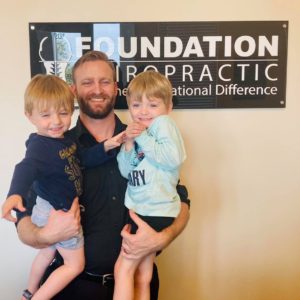 Dr. Berner holding pediatric patients.